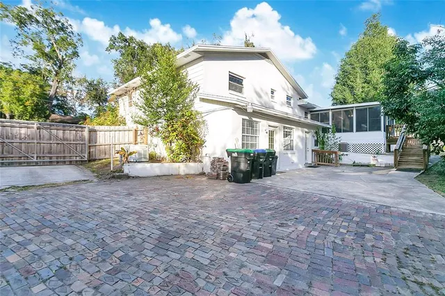 a view of a house with backyard and a tree