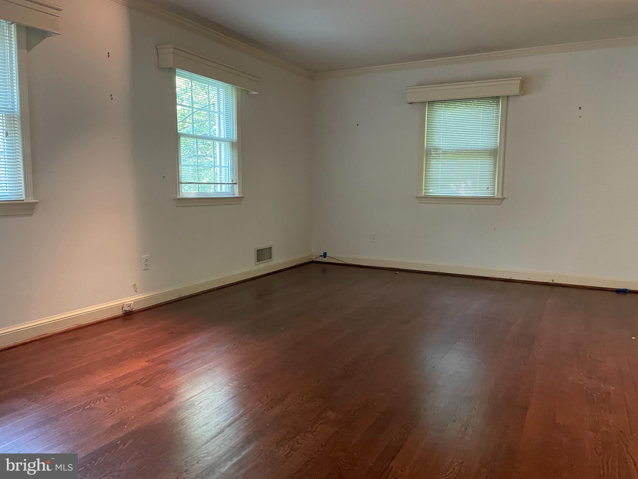 2266 48th Street Northwest Washington, DC 20007 - Photo 13 of 28 an empty room with wooden floor and windows