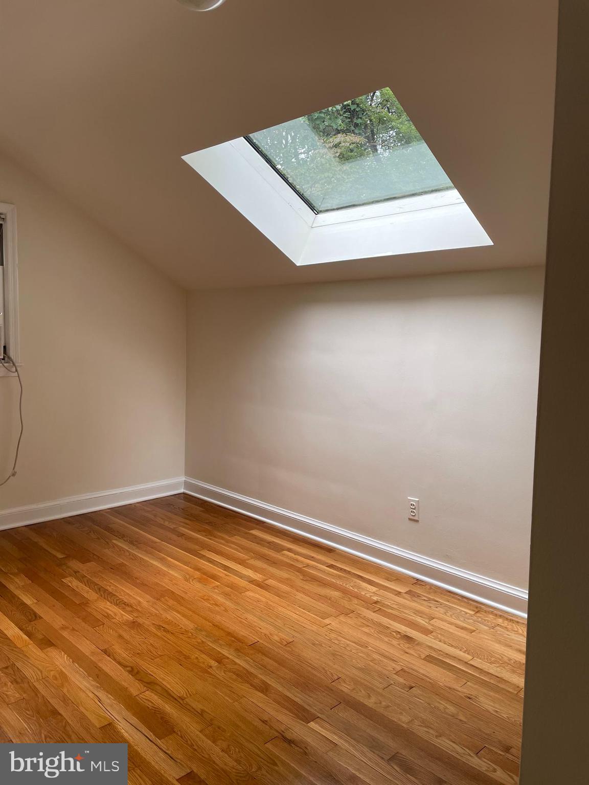 2266 48th Street Northwest Washington, DC 20007 - Photo 15 of 28 an empty room with wooden floor and windows