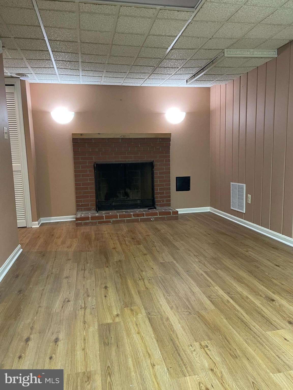 2266 48th Street Northwest Washington, DC 20007 - Photo 16 of 28 a view of an empty room with wooden floor and a fireplace
