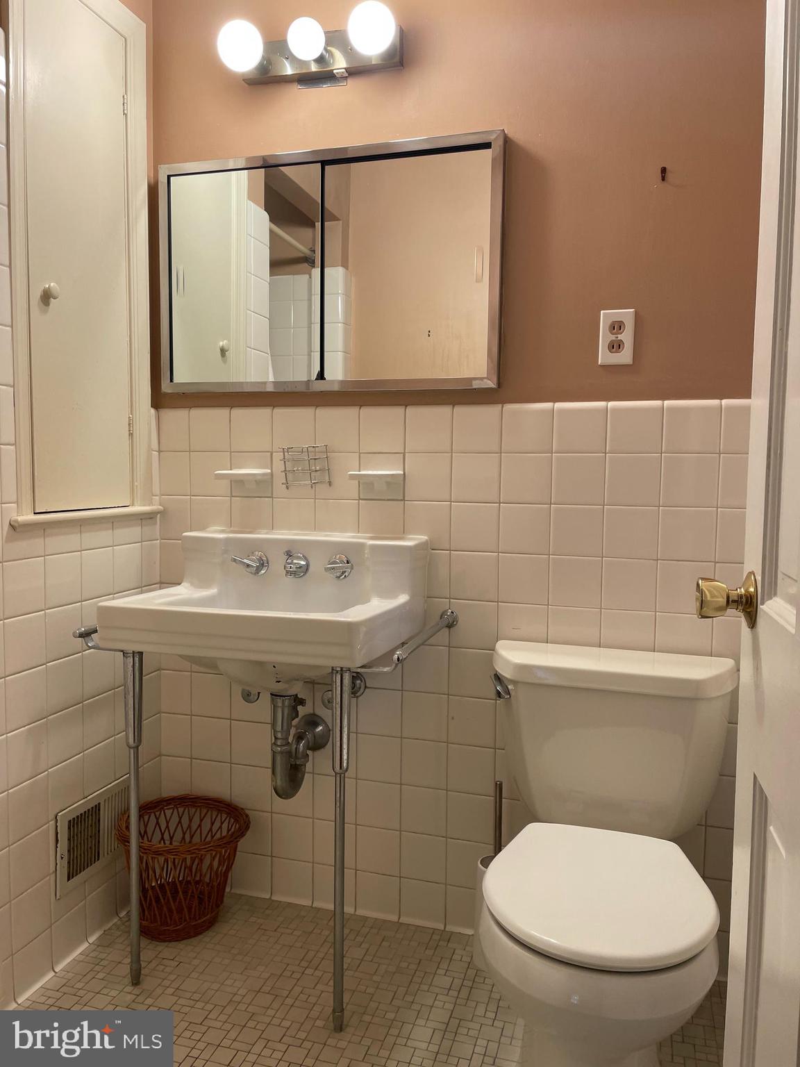 2266 48th Street Northwest Washington, DC 20007 - Photo 20 of 28 a bathroom with a toilet a sink and mirror
