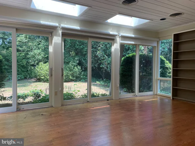 a view of a room with wooden floor and balcony