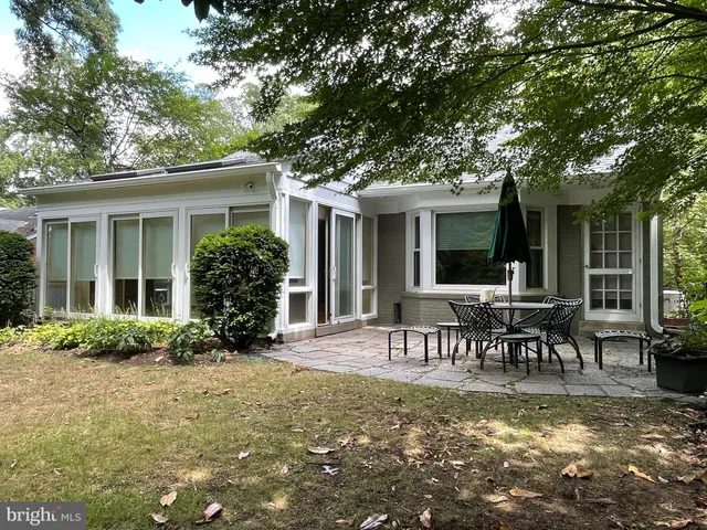 a view of a house with backyard and sitting area