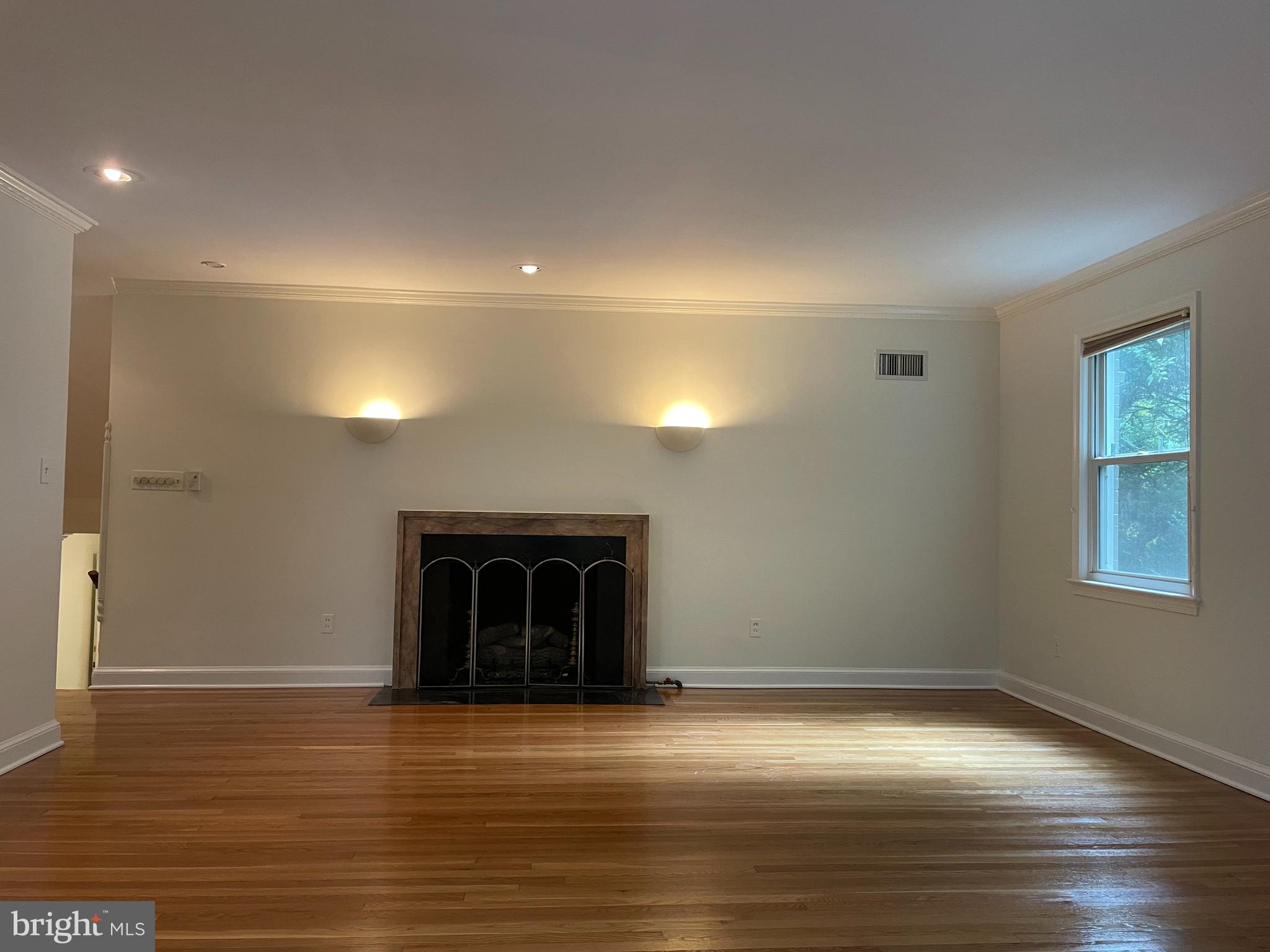 2266 48th Street Northwest Washington, DC 20007 - Photo 4 of 28 an empty room with wooden floor and a window