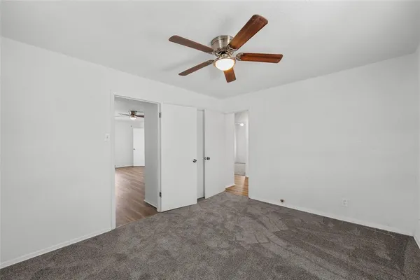 a view of a livingroom with a ceiling fan and window
