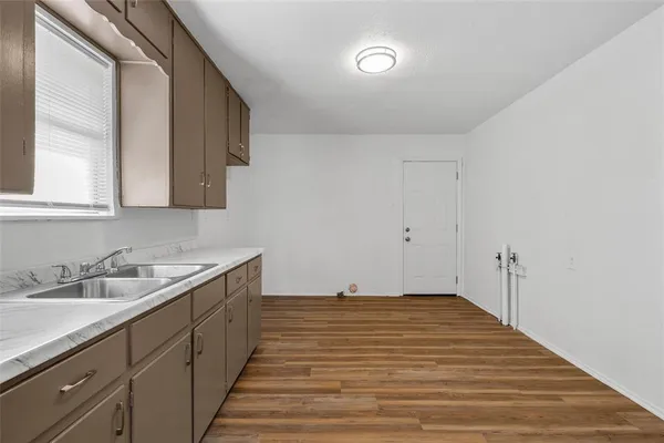 a room with a sink and cabinets