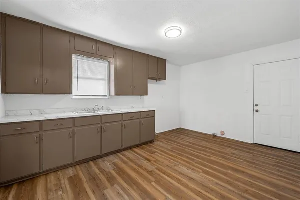 a kitchen with sink and cabinets