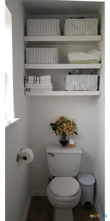 a white toilet sitting next to a bathroom sink