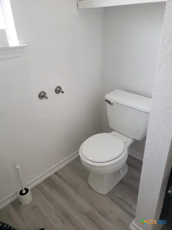 a white toilet sitting next to a white sink