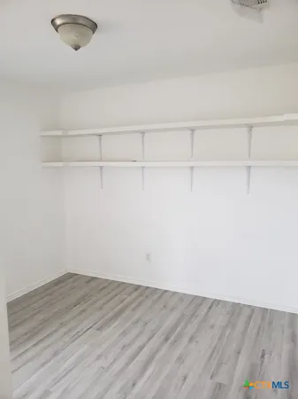 a view of a room with wooden floor