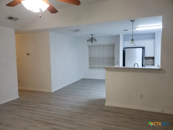 a view of a kitchen cabinets and wooden floor