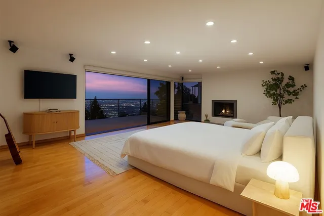 a bed room with a bed and a television