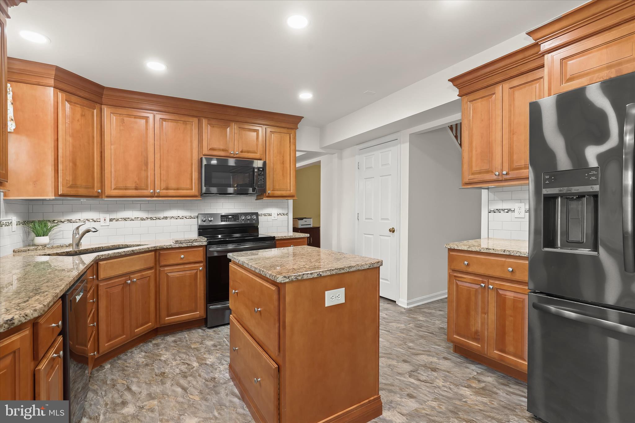 6463 Tydings Road Sykesville, MD 21784 - Photo 12 of 104 a kitchen with stainless steel appliances granite countertop a stove a sink dishwasher a refrigerator and a microwave