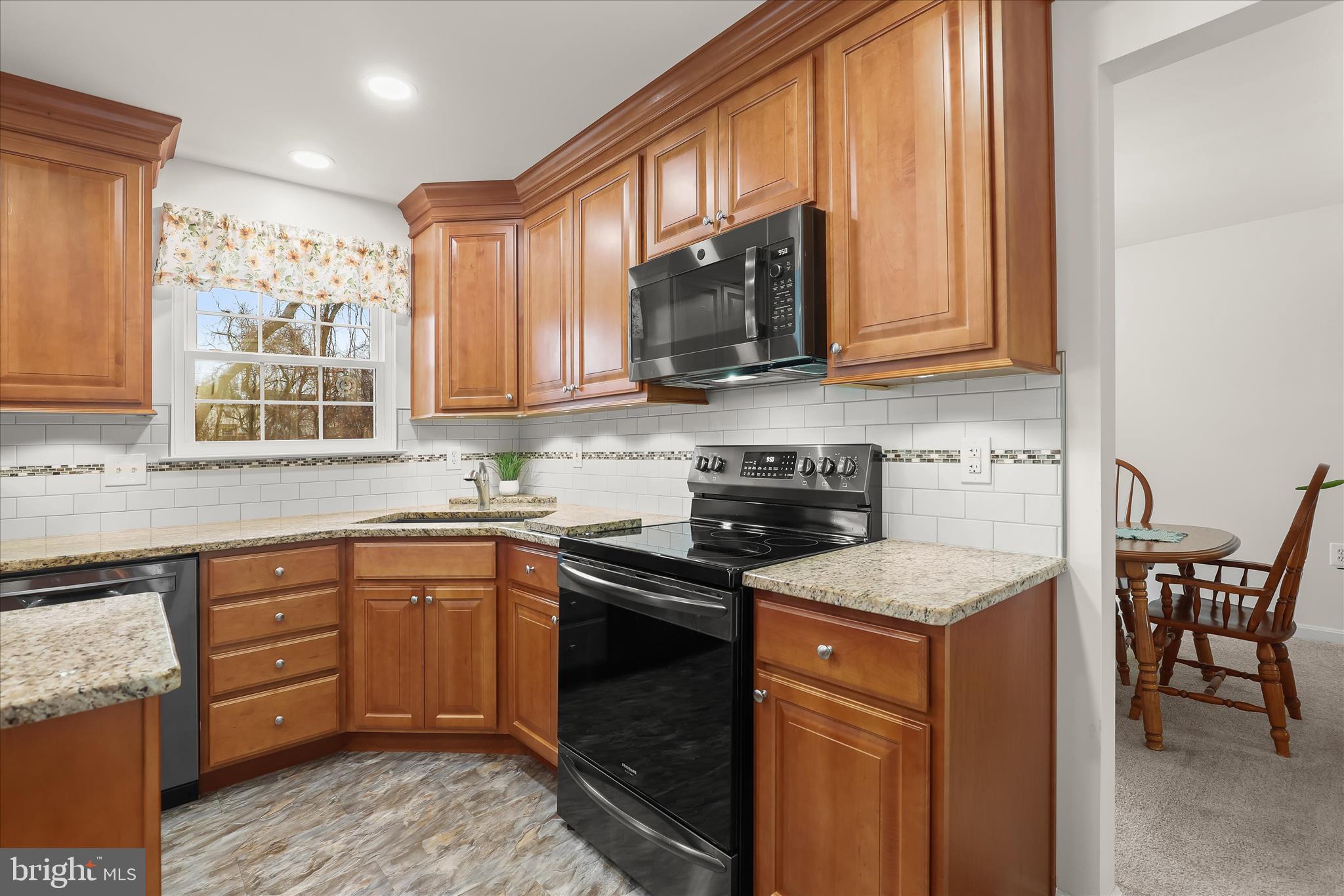 6463 Tydings Road Sykesville, MD 21784 - Photo 13 of 104 a kitchen with stainless steel appliances granite countertop a stove a sink dishwasher and a microwave oven with cabinets