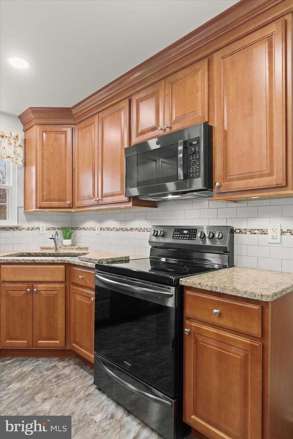 6463 Tydings Road Sykesville, MD 21784 - Photo 16 of 104 a kitchen with granite countertop a stove sink and microwave