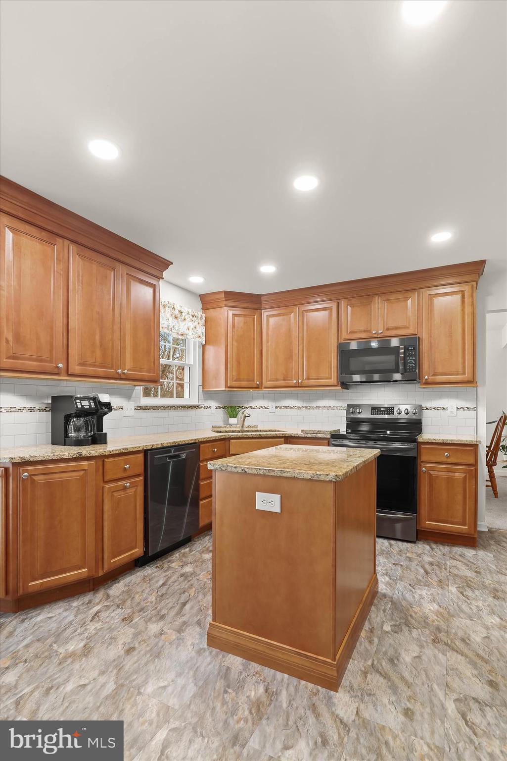 6463 Tydings Road Sykesville, MD 21784 - Photo 17 of 104 a large kitchen with stainless steel appliances granite countertop a stove top oven a sink dishwasher a dining table and chairs