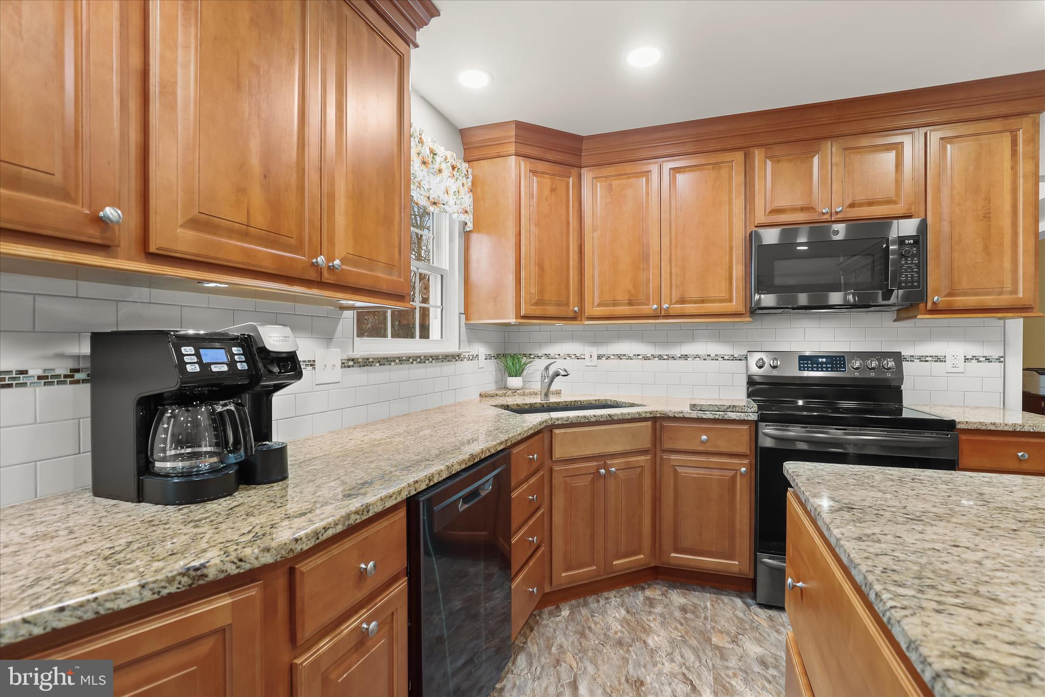 6463 Tydings Road Sykesville, MD 21784 - Photo 2 of 104 a kitchen with granite countertop a sink a stove top oven a counter space and cabinets