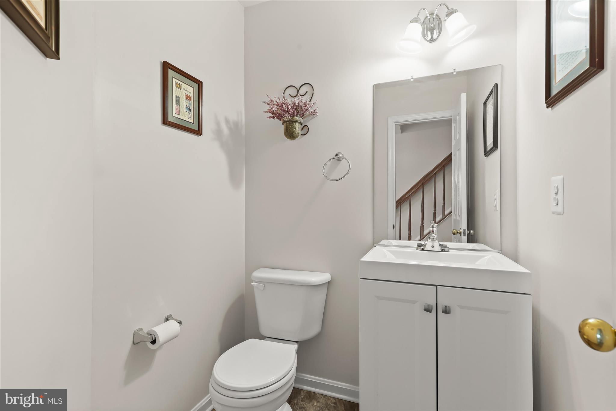 6463 Tydings Road Sykesville, MD 21784 - Photo 26 of 104 a bathroom with a toilet sink and mirror