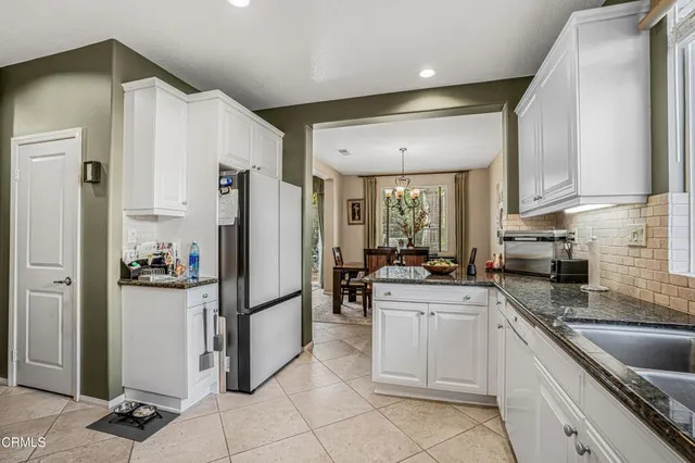 a kitchen with refrigerator and cabinets