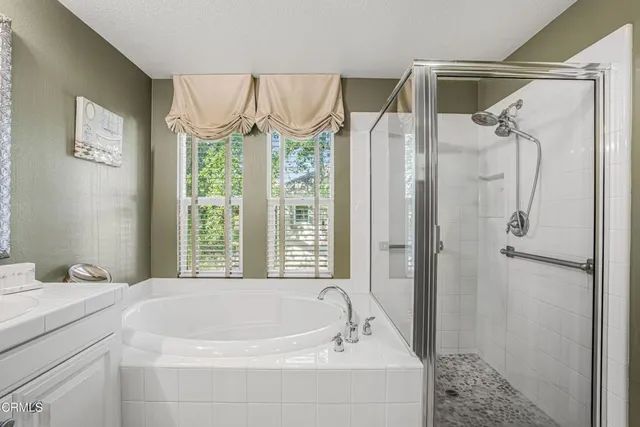 a bathroom with a bathtub and a shower