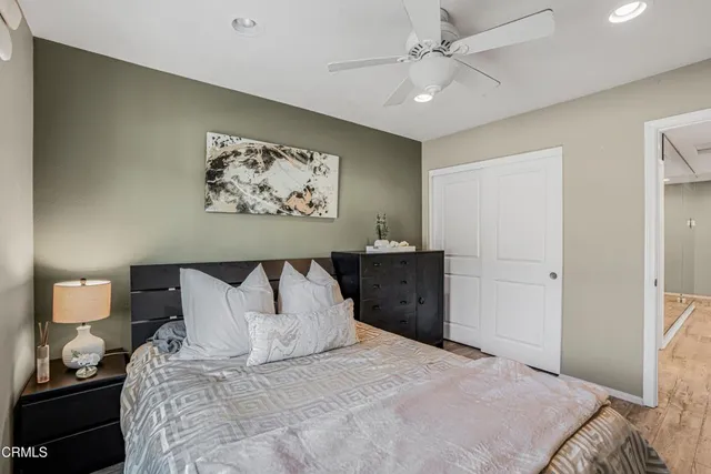 a bedroom with a bed and a painting on the wall