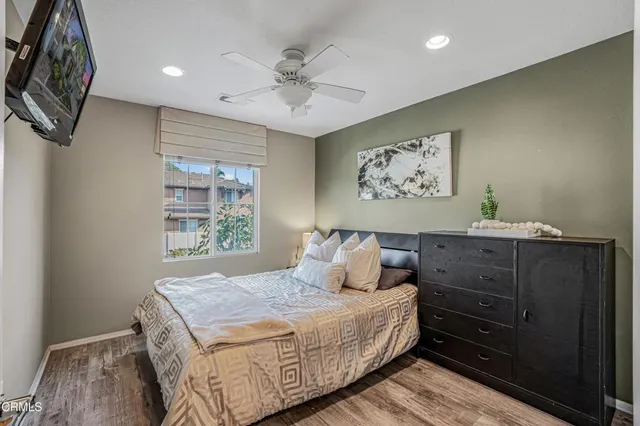 a bedroom with a bed and a painting on the wall