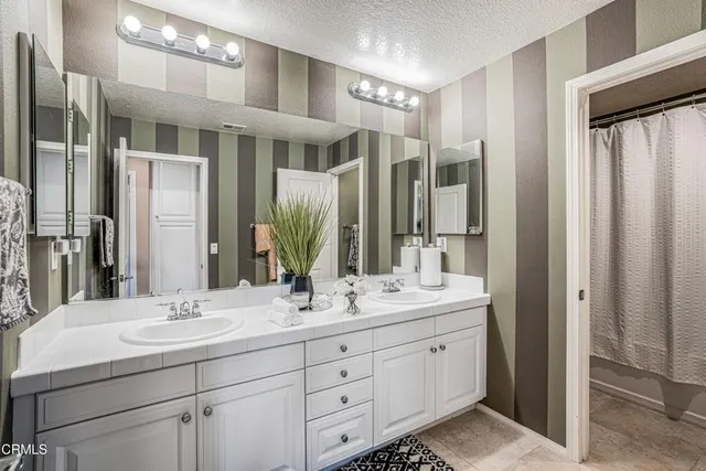 a bathroom with a double vanity sink mirror and double