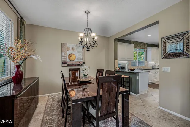 a view of a dining room with furniture and chandelier