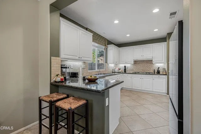 a kitchen with stainless steel appliances granite countertop a sink and cabinets