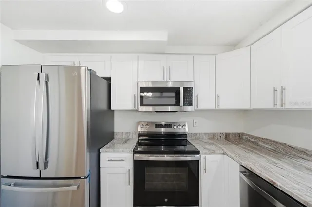 a kitchen with a stove microwave and refrigerator