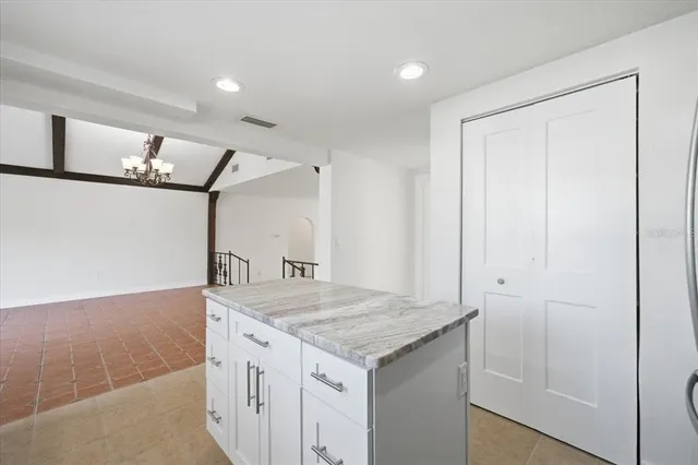 a kitchen with a sink cabinets and wooden floor