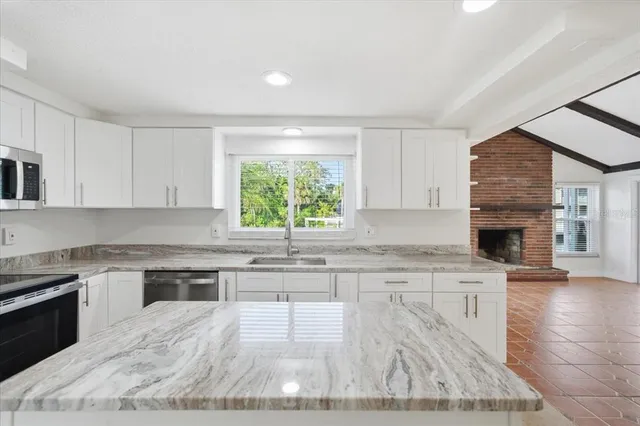 a kitchen with a stove a sink and a microwave