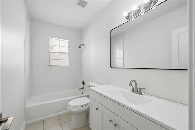a white toilet sitting next to a bathroom sink