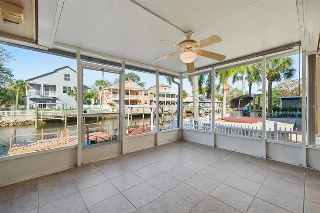 a view of a room with window and ceiling fan