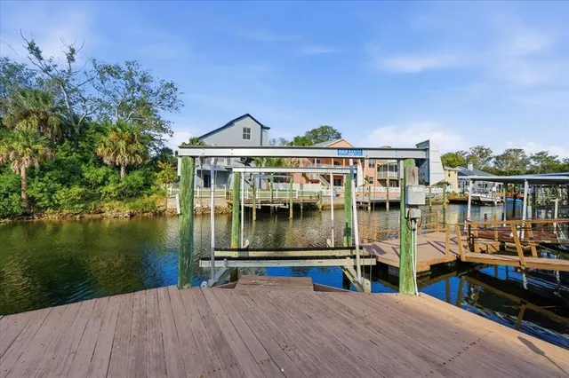 a view of swimming pool with outdoor seating and house in the background