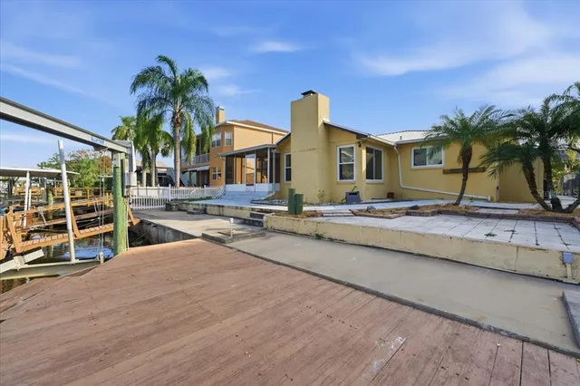 a view of a house with pool and sitting area