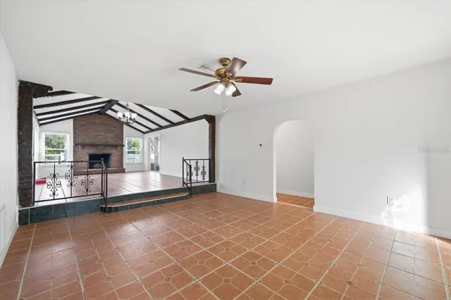 a view of a livingroom with a ceiling fan and wooden floor