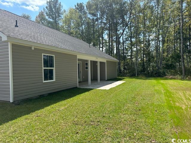 3393 Dusty Road Loris, SC 29569 - Photo 3 of 15 Back of property featuring a lawn and a patio