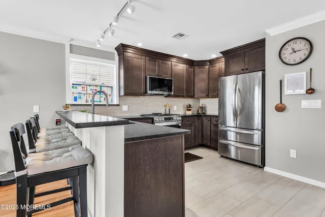 a kitchen with stainless steel appliances wooden cabinets and a sink