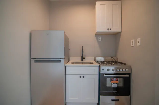 a kitchen with a refrigerator and cabinets