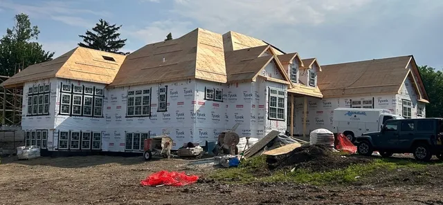 a view of a chairs and table in the backyard