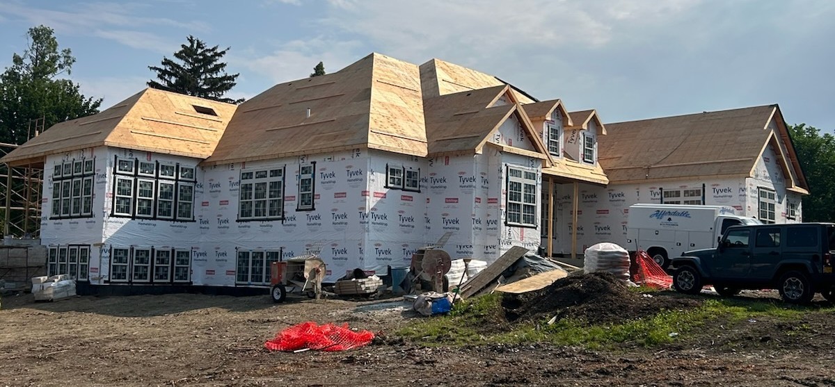 a view of a chairs and table in the backyard