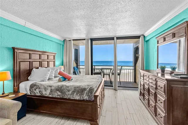a bedroom with a large bed and a balcony