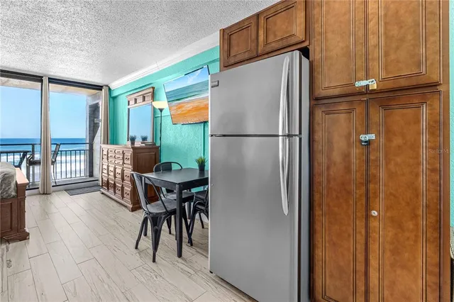 a kitchen with stainless steel appliances granite countertop a refrigerator and a table