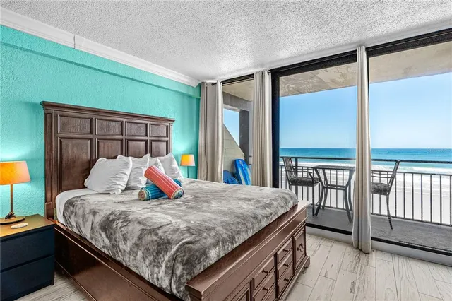 a bedroom with a bed and a large window