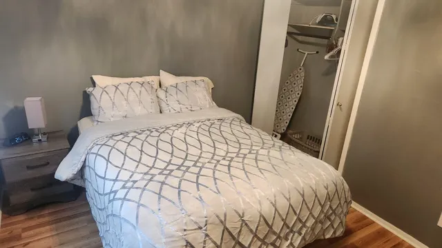 a bed sitting in a bedroom next to a small yard