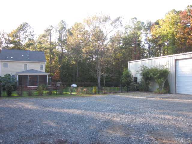 10024 Baileywick Road Raleigh, NC 27613 - Photo 11 of 25 Shop parking and exterior back of home! Seller will remove shop at no cost if buyer would like it removed, but not the concrete pad!