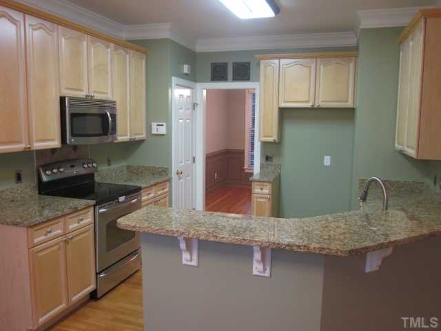 10024 Baileywick Road Raleigh, NC 27613 - Photo 13 of 25 Kitchen updates two years new! Granite counter tops, stainless steel appliances, warming drawer on bottom of oven, built in microwave, roll outs and pantry!