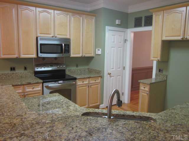 10024 Baileywick Road Raleigh, NC 27613 - Photo 14 of 25 More kitchen features include 42" raised panel maple cabinets with crown molding, hardwood floors, roll outs and a pantry! Door leads to dining room for ease in entertaining!