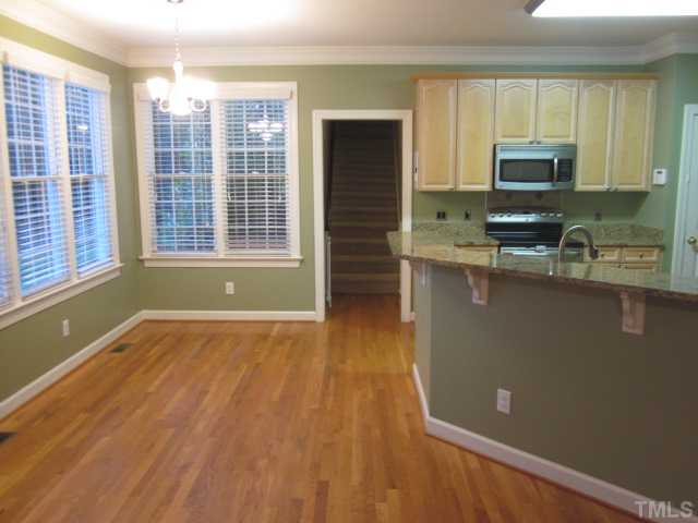 10024 Baileywick Road Raleigh, NC 27613 - Photo 15 of 25 Great view of the breakfast area and eat at bar! More home features include 9' smooth ceilings, tilt in windows, security system, 2 inch blinds and hardwood floors!